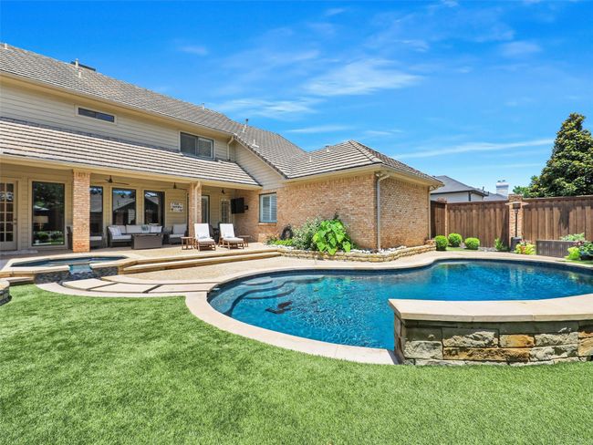 View of pool with an in-ground hot tub, outdoor lounge area, and a patio | Image 32