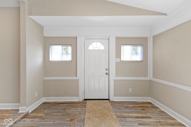 foyer with wood finished floors, healthy amount of natural light, lofted ceiling, and baseboards | Image 6