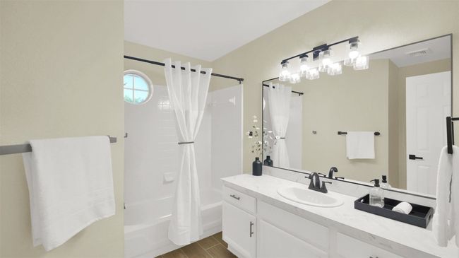 Full bath with vanity, wood finished floors, visible vents, and shower / bathtub combination with curtain | Image 10