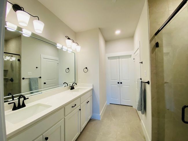 Large primary bathroom with dual sinks and walk in closet. | Image 10