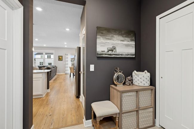 This well-appointed mudroom with closet will keep the household organized and provides access to the oversized, sheet-rocked two-car garage with overhead wire shelving that will remain with the property. | Image 10