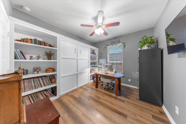 Office area featuring light wood-style floors and ceiling fan | Image 12