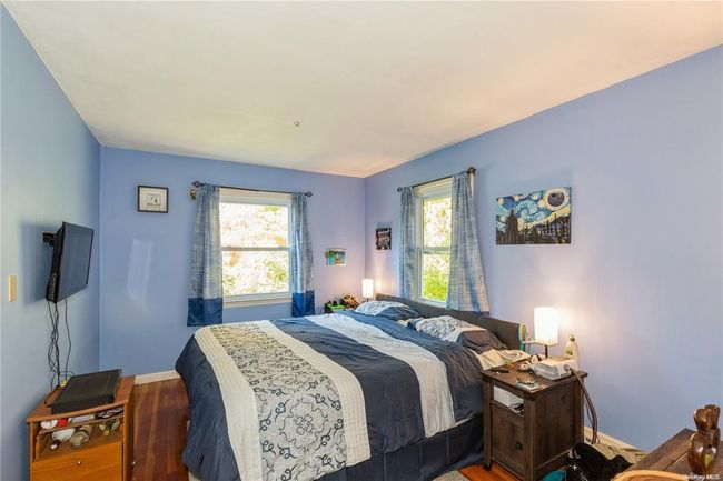 Bedroom featuring baseboards and wood finished floors | Image 19