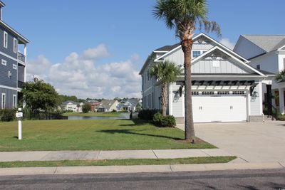 View of front of home featuring a garage and a front lawn | Image 2