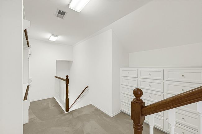 Elevate your storage with this second-floor primary closet featuring elegant custom drawers. | Image 30