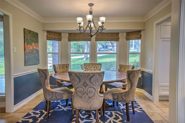 Dining room featuring baseboards, bright windows, a chandelier, and ornamental molding | Image 17