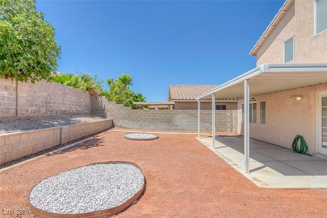 Fenced backyard with a patio area | Image 33