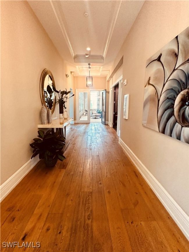 Community Amenities featuring a tray ceiling, hardwood / wood-style flooring, and french doors | Image 44