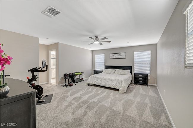 Bedroom with carpet, baseboards, and multiple windows | Image 37