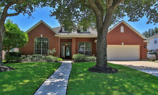 The inviting shaded path leads guests up to the beautiful all-brick home | Image 4