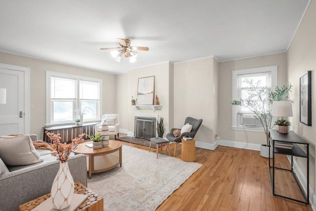 Mail level living room with wood burning fireplace. | Image 4