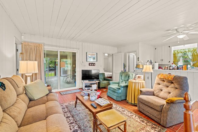 Living room featuring plenty of natural light, ceiling fan, and wooden ceiling | Image 4