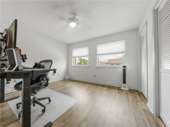 Office with a ceiling fan and wood finished floors | Image 11