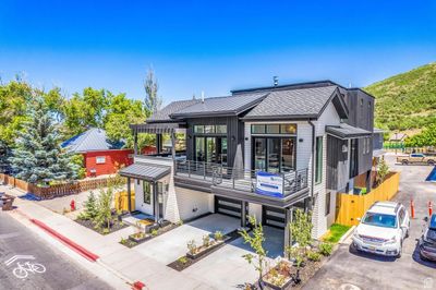 View of front of house featuring a garage and a balcony | Image 1