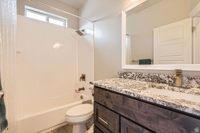 Bathroom featuring shower / bathtub combination and vanity | Image 18