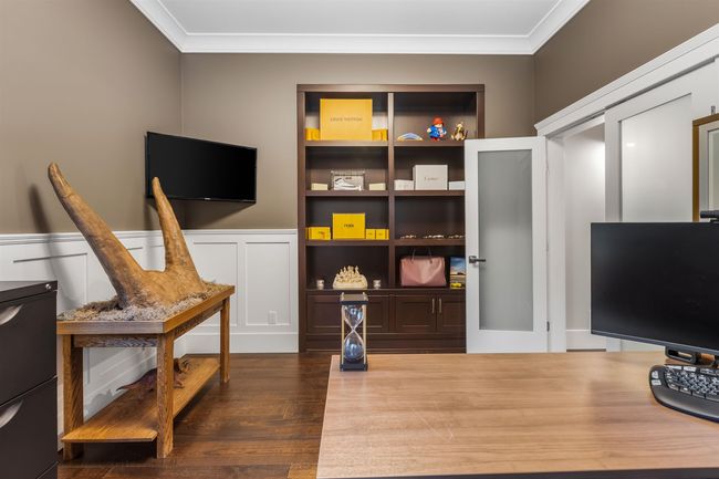Sitting room featuring a decorative wall, dark wood-style flooring, crown molding, and wainscoting | Image 16