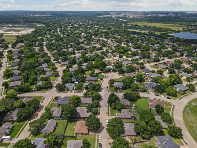 Aerial view of property's location featuring a large body of water and nearby suburban area | Image 29