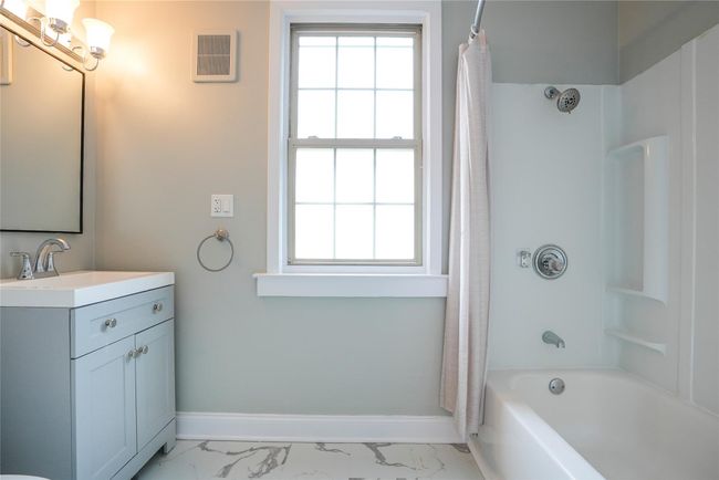 Full bathroom with marble finish floor, baseboards, and plenty of natural light | Image 15