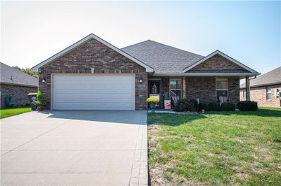 View of front facade featuring a garage and a front lawn | Image 1