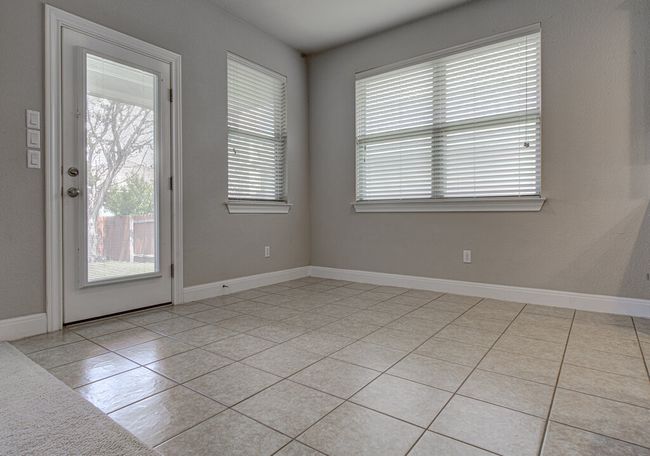 Empty room with light tile patterned floors and baseboards | Image 10