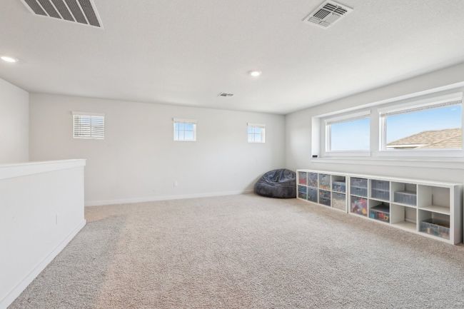 Upstairs, discover the possibilities of this spacious loft – a media lounge, playroom, or cozy retreat. | Image 28