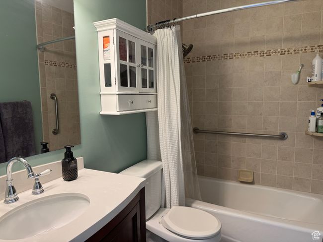 Full bath featuring vanity and shower / bath combination with curtain | Image 15