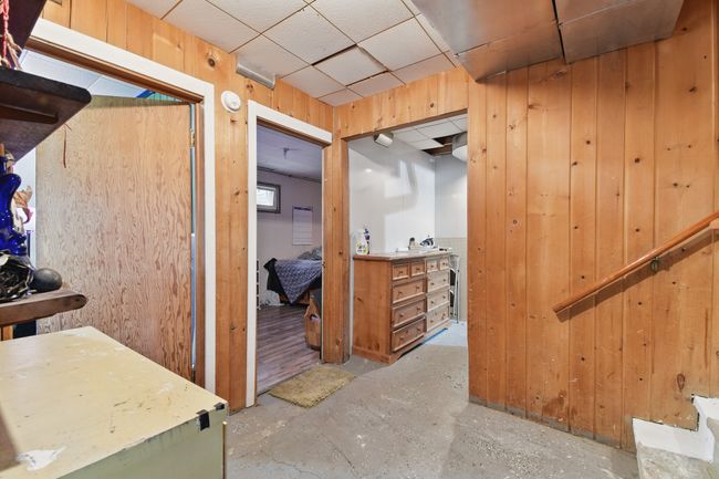 Hallway featuring concrete floors and wooden walls | Image 22