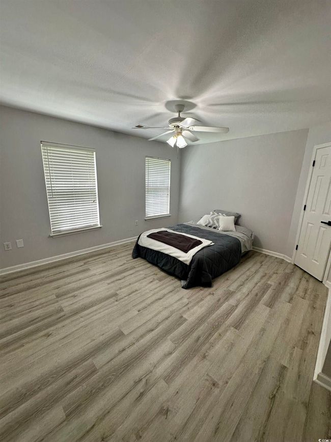 Spare room with light wood-style flooring, baseboards, and a ceiling fan | Image 12