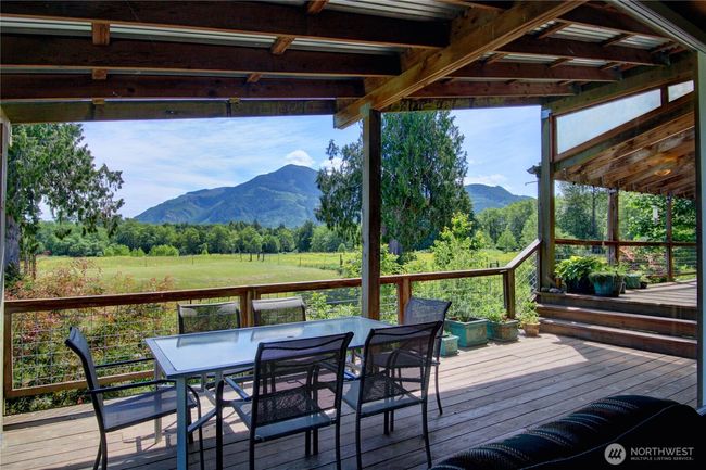 Deck access from great room off backside of lodge with pastoral & mountain views | Image 9