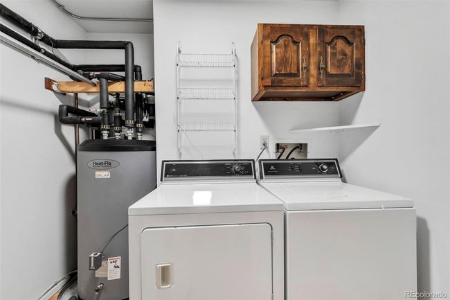 Laundry room on main floor with solar water heater in background | Image 27