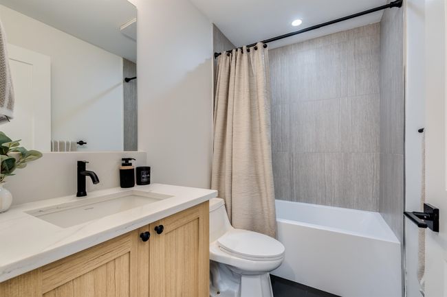 Bathroom featuring shower / bath combo, vanity, and toilet | Image 11