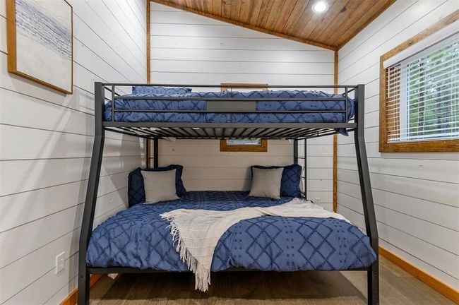 Bedroom featuring wood-type flooring and vaulted ceiling | Image 31