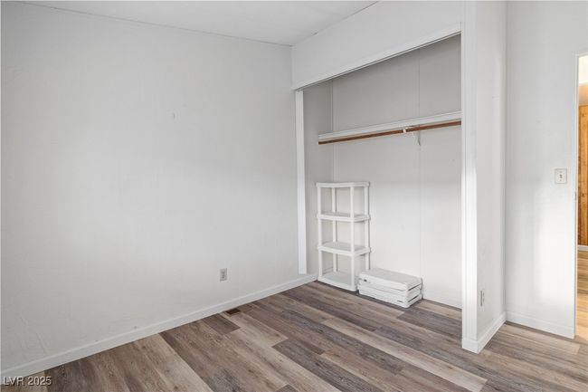 Bedroom featuring a closet, baseboards, and wood style floors | Image 16