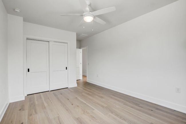 Unfurnished bedroom with baseboards, light wood-style flooring, a closet, and a ceiling fan | Image 21