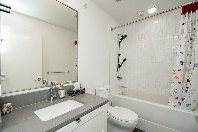 Bathroom with vanity, shower / bath combo with shower curtain, and toilet | Image 24