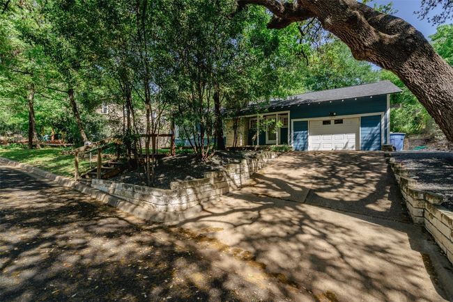 Right side view of property, offering an over sized single car garage, plenty of room for storage etc... | Image 6