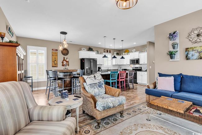 Living area with baseboards, light wood-type flooring, and recessed lighting | Image 8