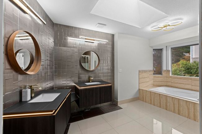 Full bath with tile patterned floors, tasteful backsplash, a sink, and two vanities | Image 24