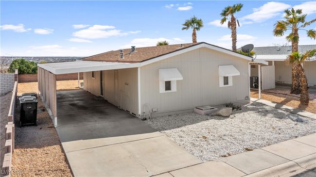 View of side of property with concrete driveway, a carport, and cooling unit | Image 61