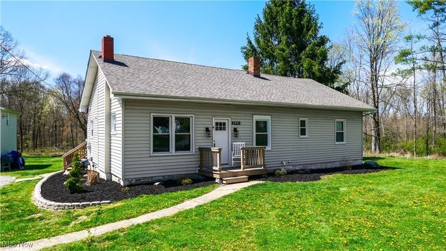 View of front of property featuring a front yard, roof with shingles, and a chimney | Image 25