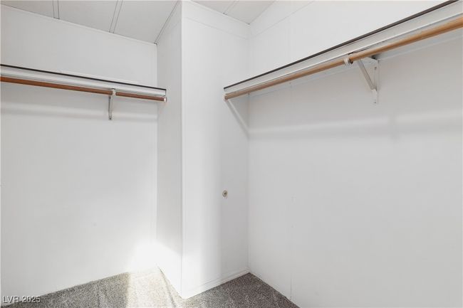 Spacious walk-in closet with carpet flooring | Image 23