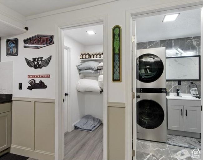Laundry area with stacked washer / dryer and cabinet space | Image 17