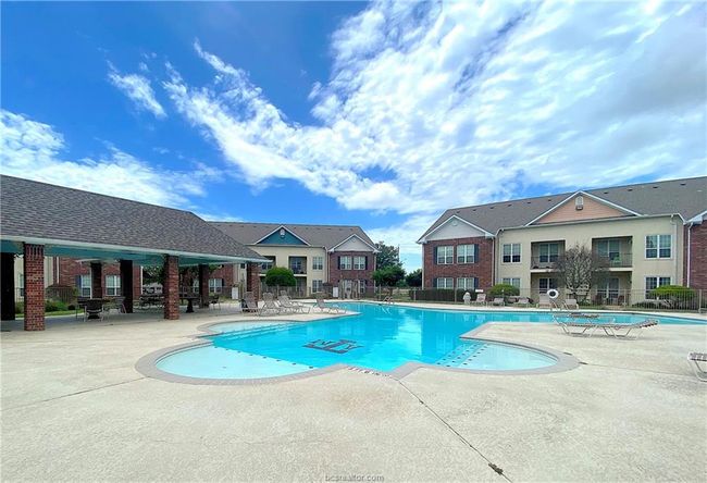 Community pool with fence and a patio | Image 12
