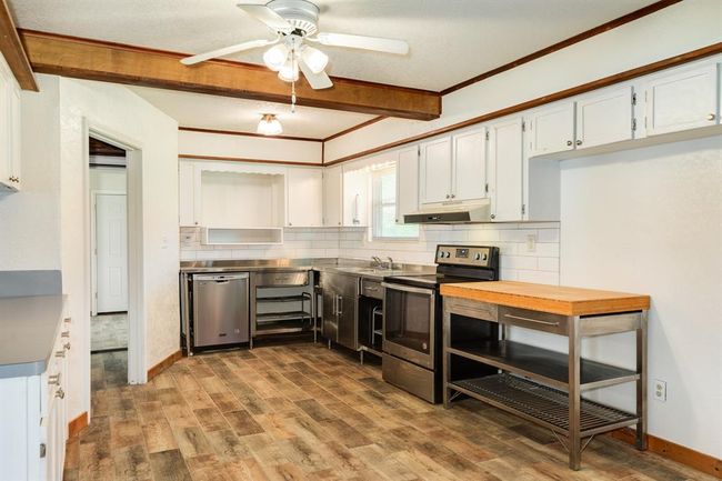 Another view of the Kitchen. These wood-look tile floors make clean-up a breeze. | Image 28