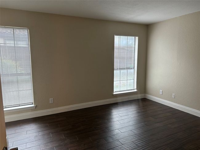Unfurnished room with dark wood-type flooring and baseboards | Image 5
