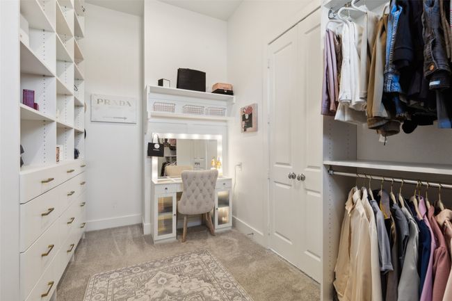 Spacious closet featuring light colored carpet | Image 21
