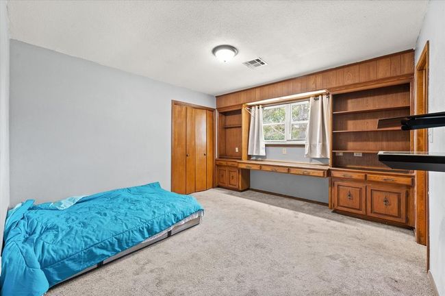 Bedroom featuring a textured ceiling and light colored carpet | Image 25