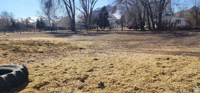 View of yard with a mountain view, a rural view, and fence | Image 30