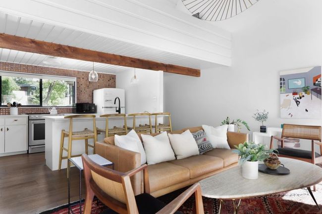 Living area featuring dark wood-style flooring and beam ceiling | Image 6