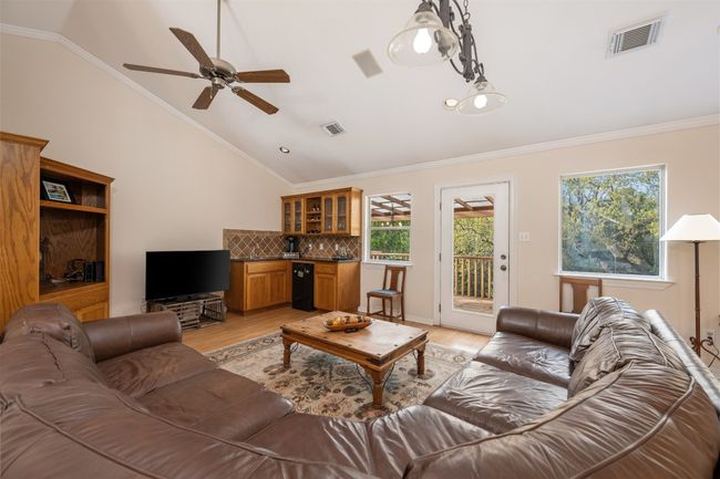 The gameroom also has its own wet bar, cabinetry, and built in bookcases. | Image 21